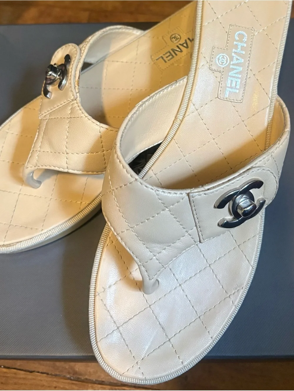 CHANEL Quilted Leather Thong Mules in Cream with Silver CC Logo